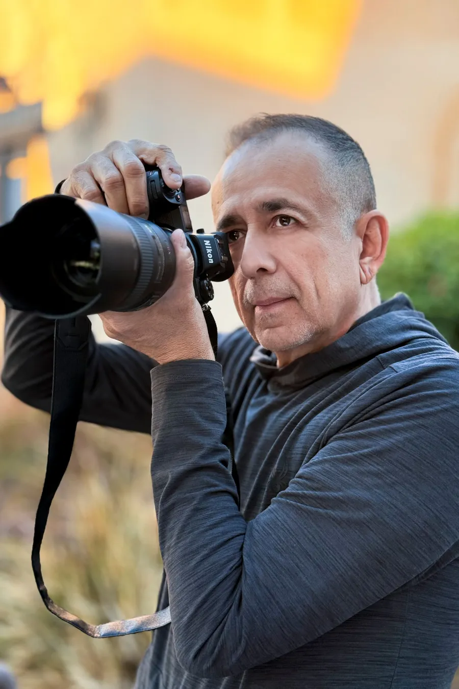 Byron Medina, restaurant and food photographer in Phoenix, holding his camera