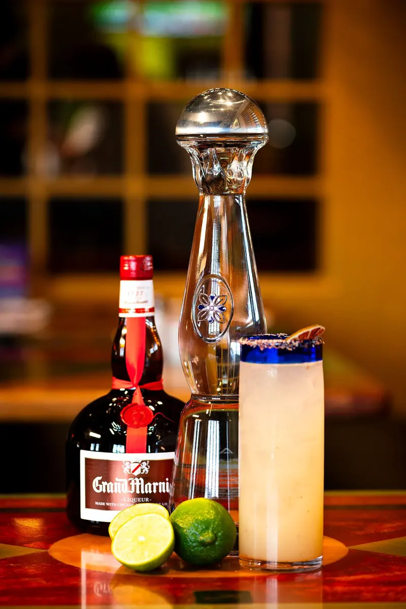 Premium tequila margarita with Grand Marnier and fresh limes on the bar