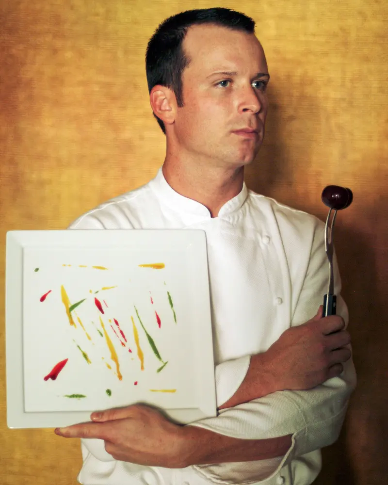 Chef portrait holding an artistic plated design