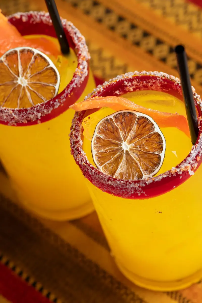 Mango margaritas with chili-salt rims and dried lime wheels
